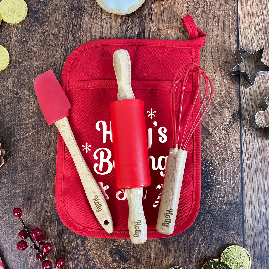Red baking set with tools on a wooden surface