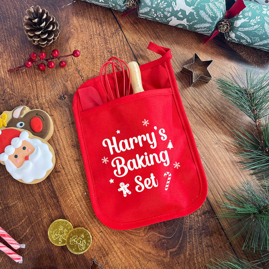 Red baking set with 'Harry's Baking Set' text on a wooden surface with Christmas decorations.